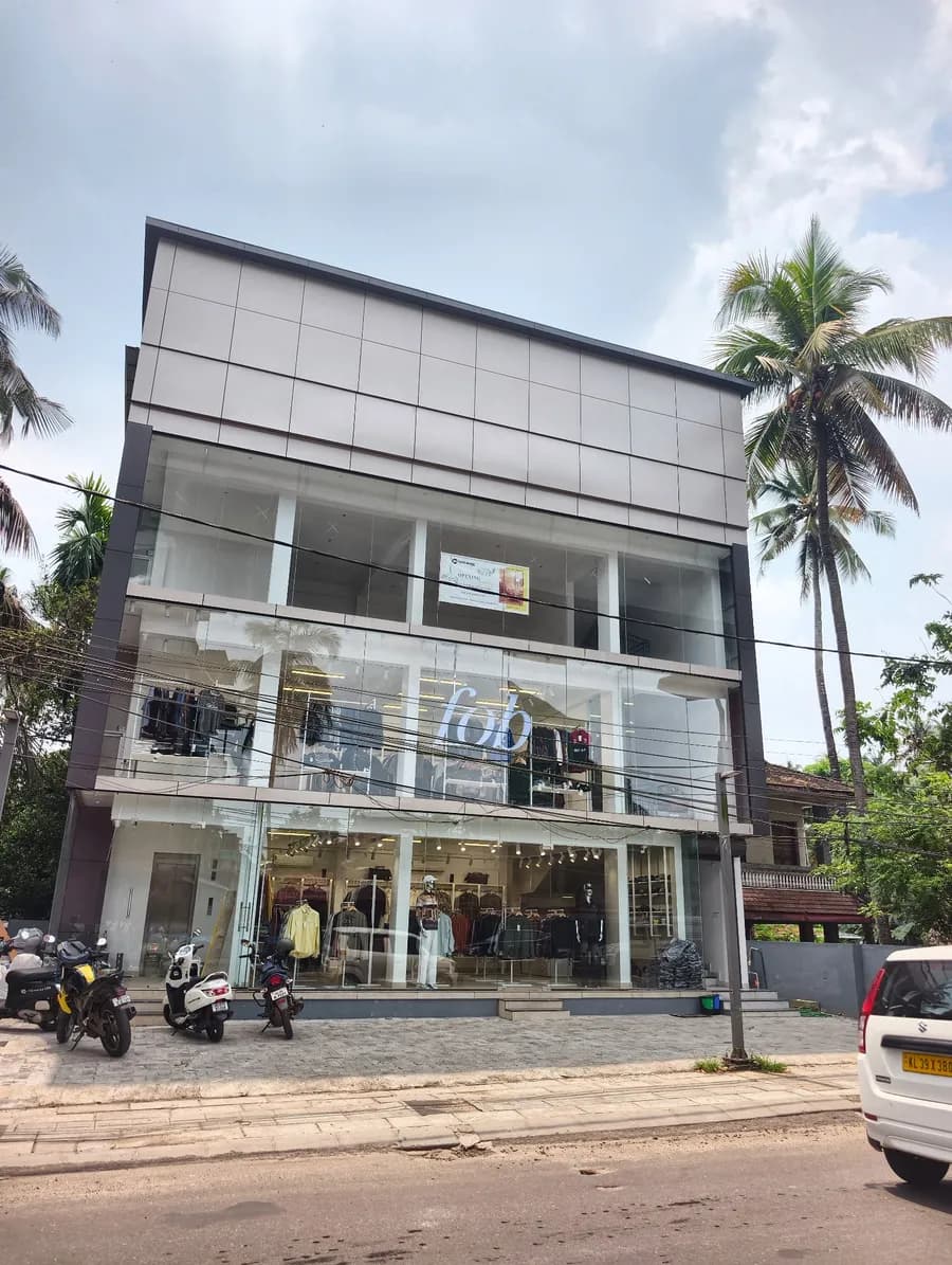 Front of the multi-storey building at SN Junction with palm trees on both sides