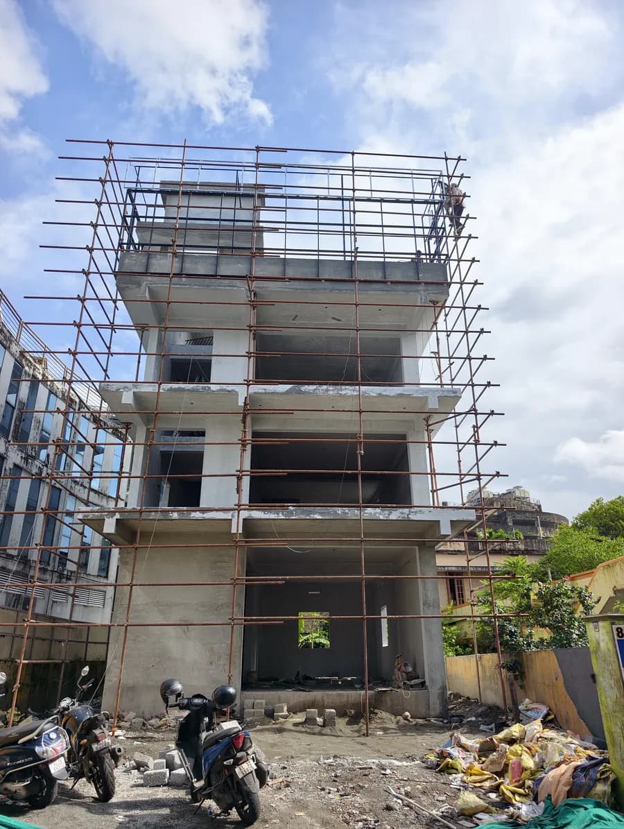 Building under construction with scaffolding around the upper floors
